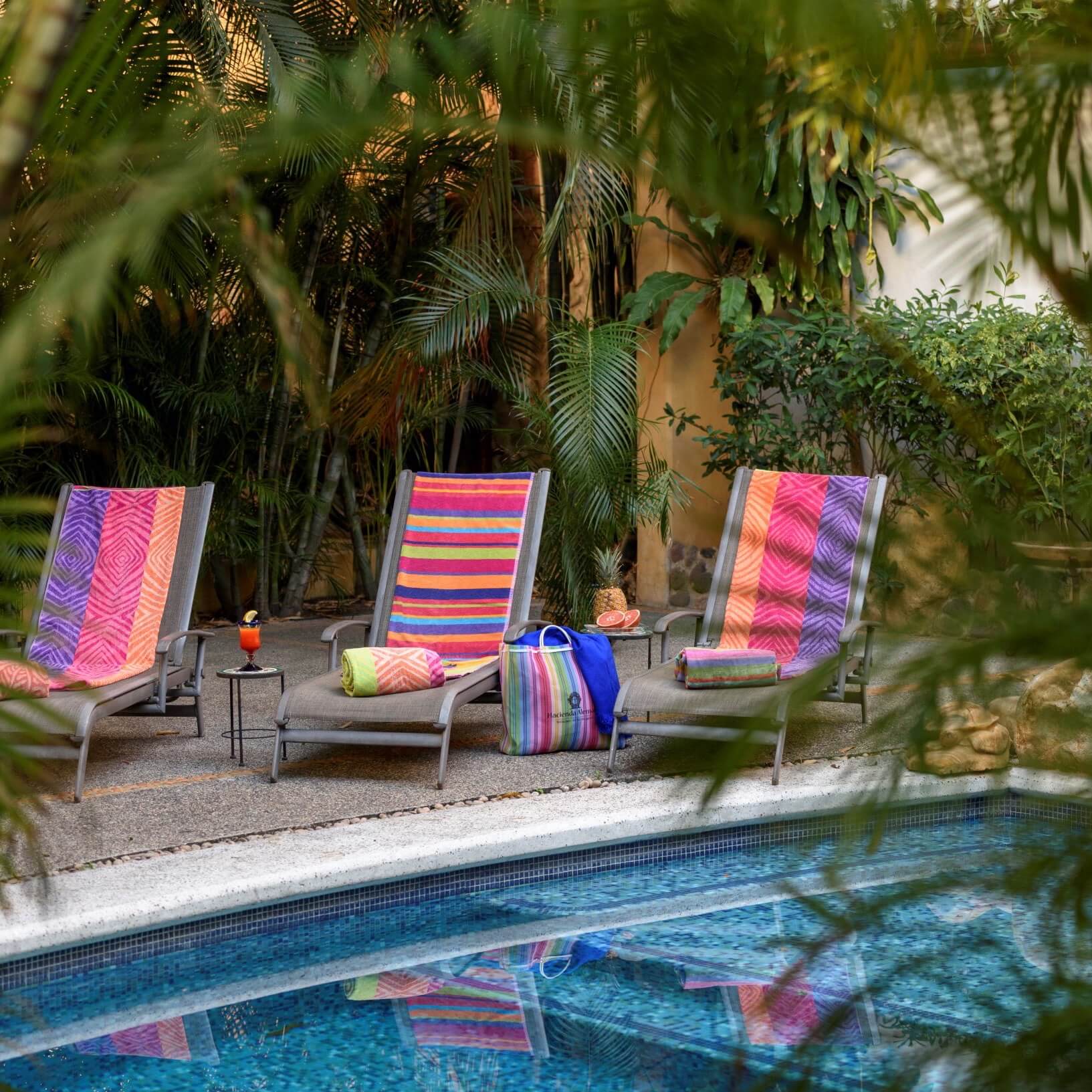Three lounge chairs by the poolside