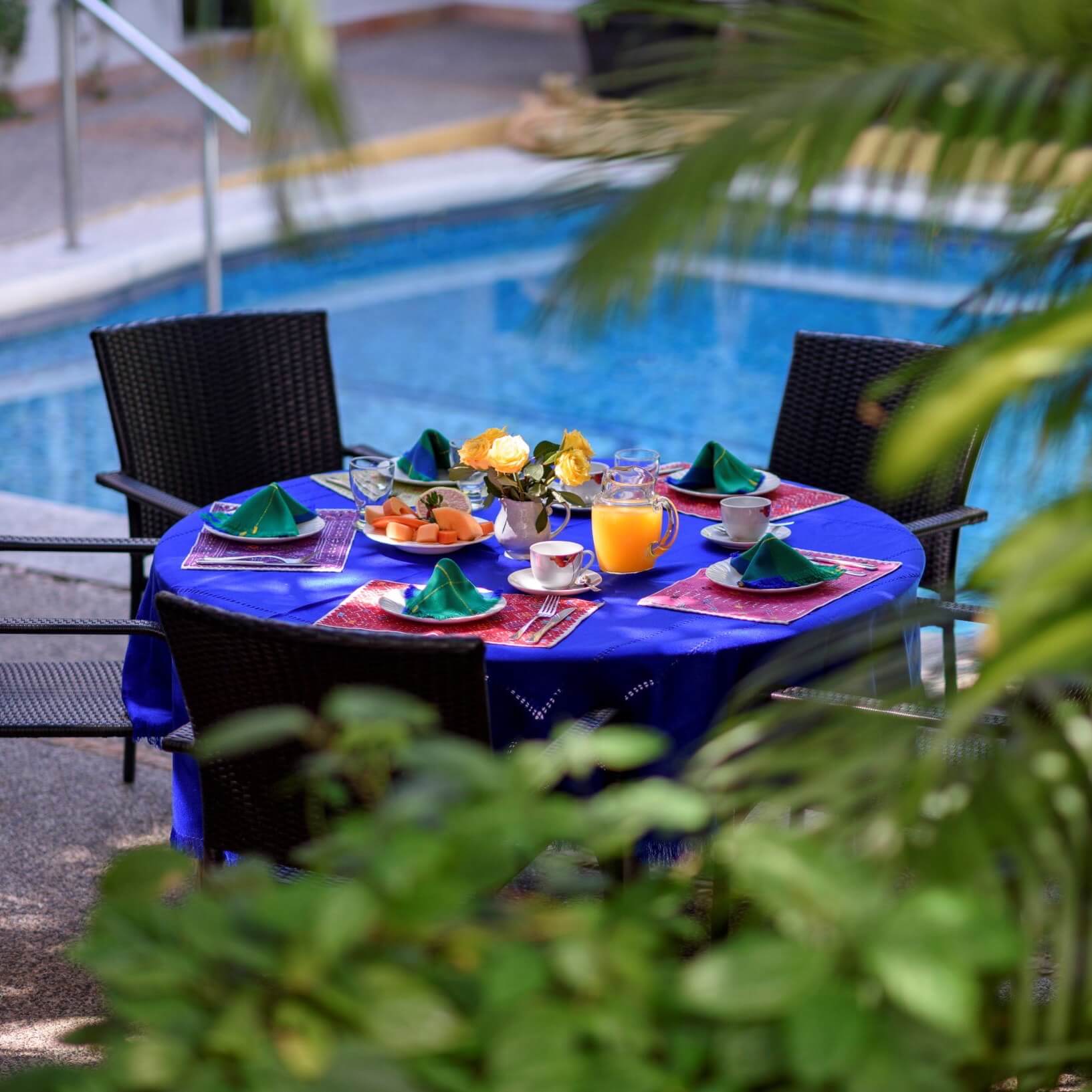 A breakfast table set by the poolside